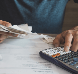 man using calculator for calculate expenses accounts